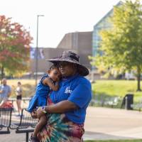 A parent and child together in front of the Kirkhof Center